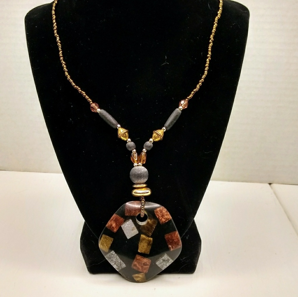 Beaded necklace with abstract pendant